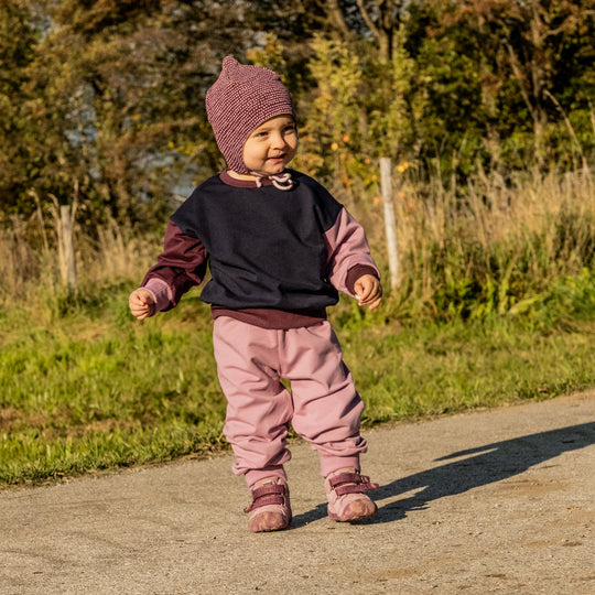 Kind trägt den leichten Sweater aus Bio-Baumwolle von Tuchwerk, bequem geschnitten für Bewegungsfreiheit und Komfort.
